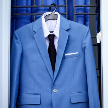 Elegant blue suit hanging on window bars